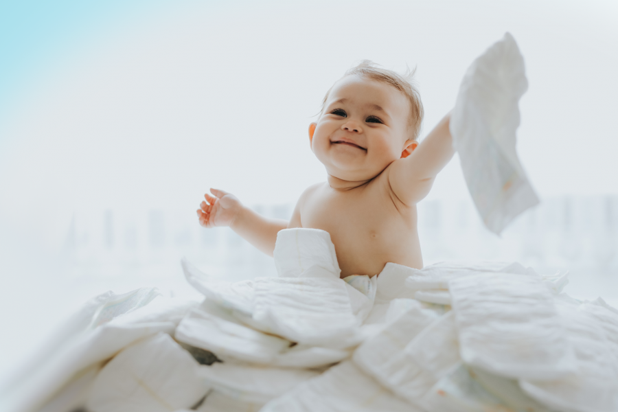 Baby holding a diaper.